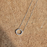 This S925 silver necklace features a delicate circular pendant encrusted with shimmering moissanite stones, forming an elegant open-circle silhouette. The slender silver chain complements the pendant perfectly, lending a refined and timeless charm to the piece. Its minimalist yet sparkling design makes it a versatile accessory for various occasions.