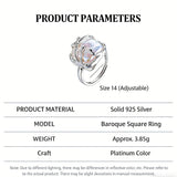 This adjustable S925 sterling silver ring features a striking baroque pearl at its center, set within an organic, flowing silver frame that wraps around the irregular, lustrous gemstone. The open, sculptural metalwork creates a modern, artistic silhouette, showcasing the pearl's natural, one-of-a-kind texture and soft iridescence. The sleek, polished silver band complements the unique pearl, making it a standout piece with a contemporary, bohemian aesthetic.