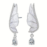 These S925 sterling silver earrings are designed in the shape of delicate butterfly wings, with a resin craft on the wing surfaces and a row of shimmering cubic zirconia along the edges. A teardrop-cut clear gemstone dangles elegantly from the bottom of each wing, adding a graceful and sparkling touch to the overall design.