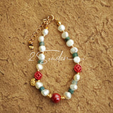 This is a bracelet made of S925 sterling silver, red cinnabars, green moss agates and natural white pearls. It's 16cm long with a 3cm extended chain. It comes with a lobster clasp which is easy to be used.