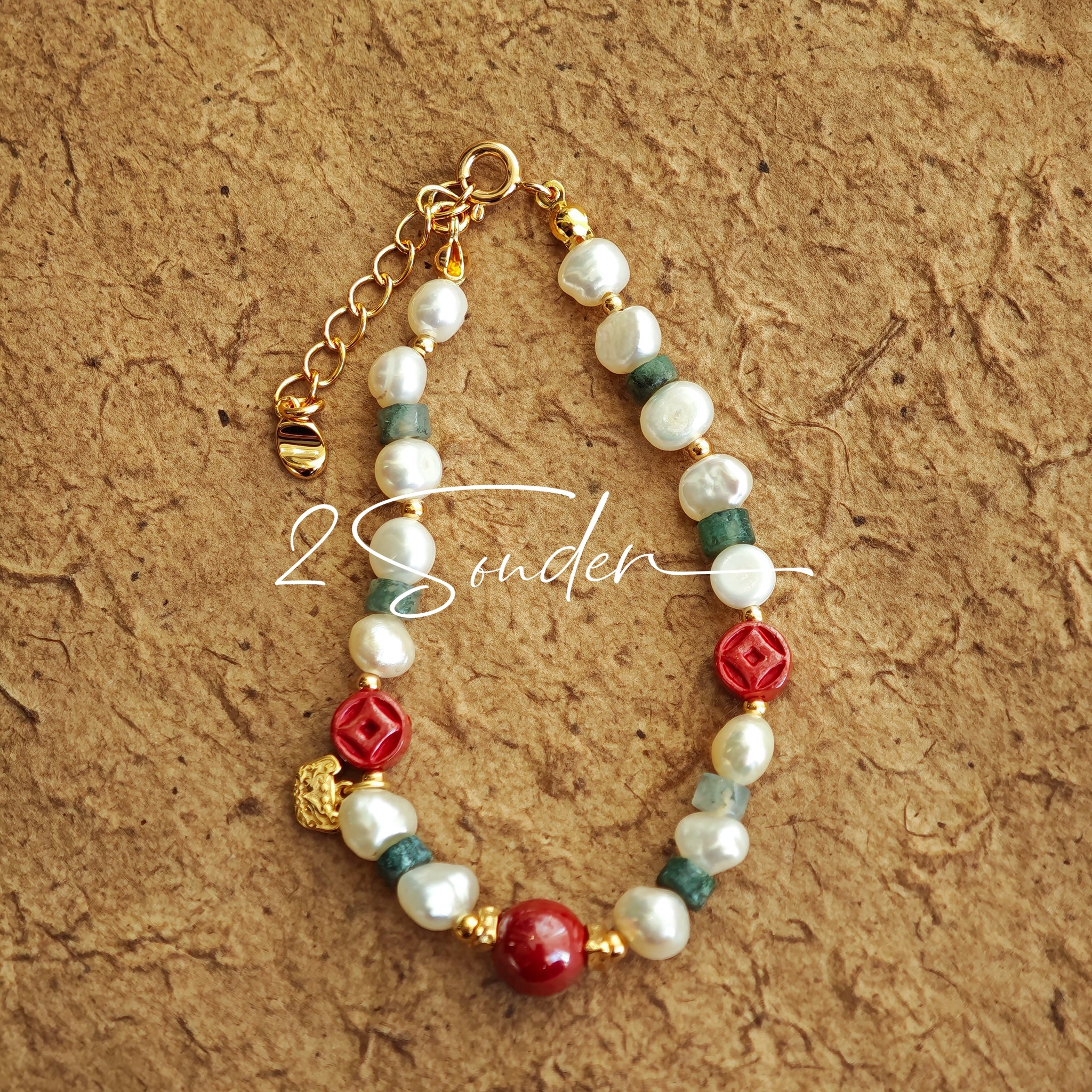 This is a bracelet made of S925 sterling silver, red cinnabars, green moss agates and natural white pearls. It's 16cm long with a 3cm extended chain. It comes with a lobster clasp which is easy to be used.
