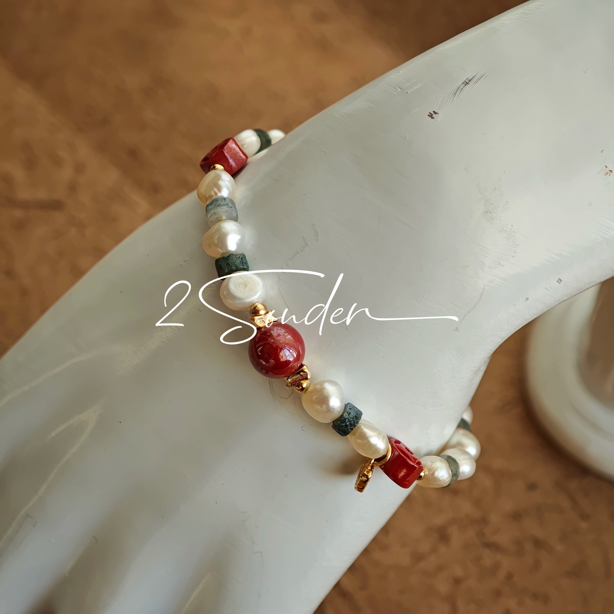 This is a bracelet made of S925 sterling silver, red cinnabars, green moss agates and natural white pearls. It's 16cm long with a 3cm extended chain. It comes with a lobster clasp which is easy to be used.