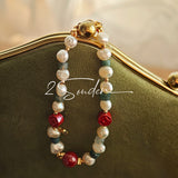 This is a bracelet made of S925 sterling silver, red cinnabars, green moss agates and natural white pearls. It's 16cm long with a 3cm extended chain. It comes with a lobster clasp which is easy to be used.