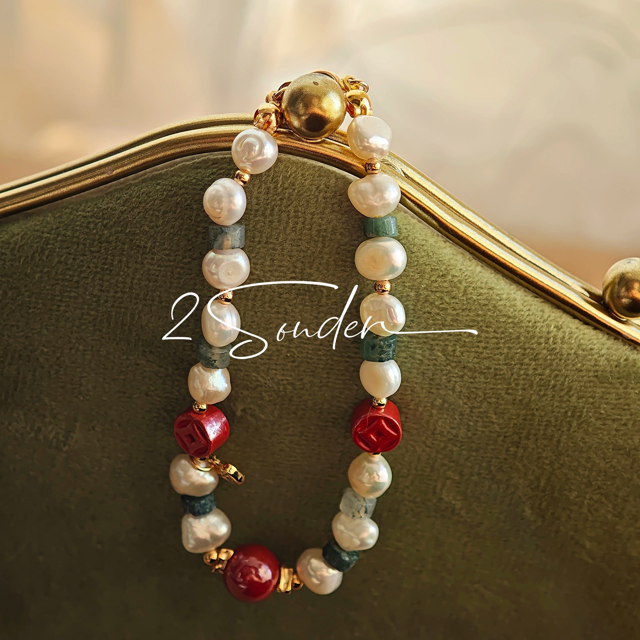 This is a bracelet made of S925 sterling silver, red cinnabars, green moss agates and natural white pearls. It's 16cm long with a 3cm extended chain. It comes with a lobster clasp which is easy to be used.