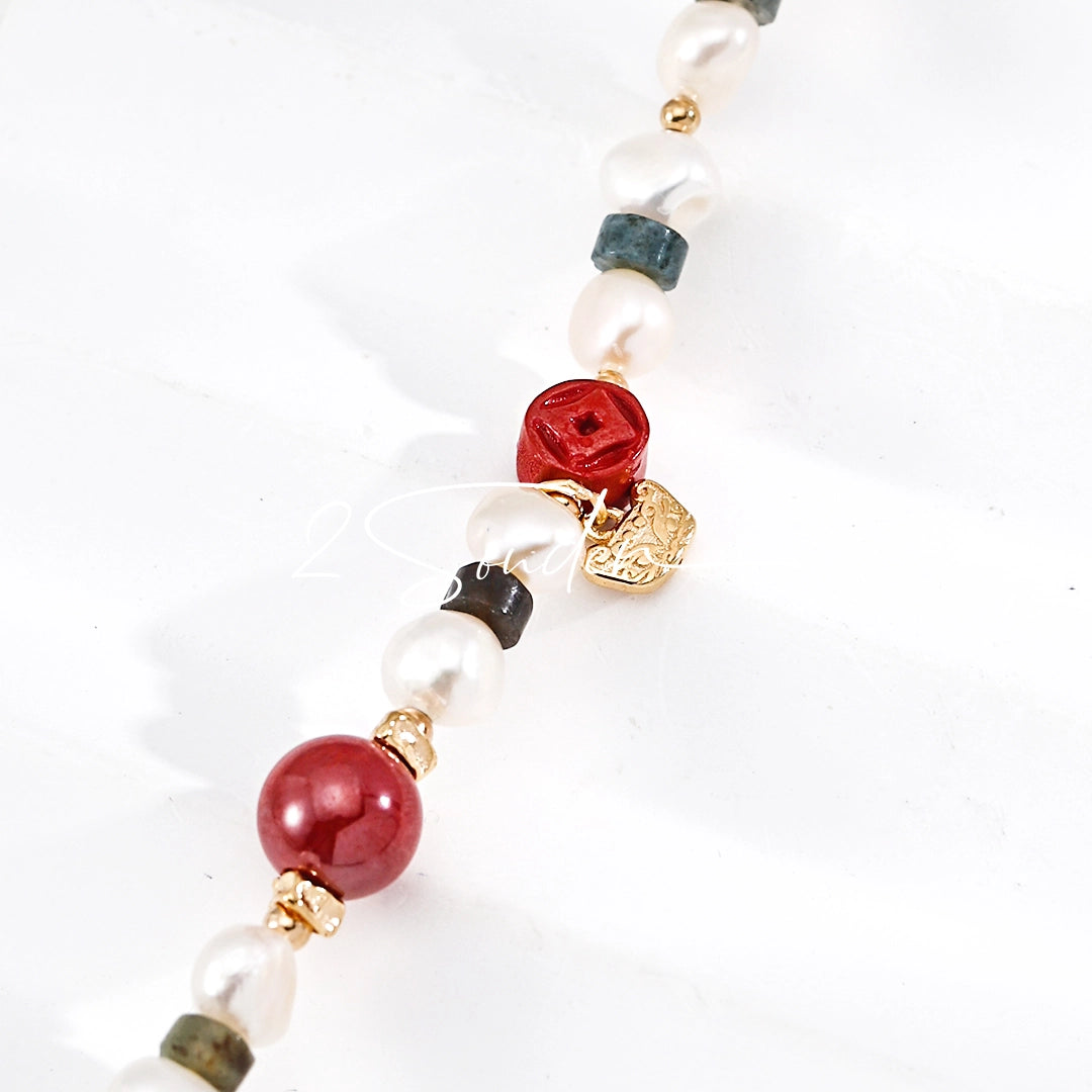 This is a bracelet made of S925 sterling silver, red cinnabars, green moss agates and natural white pearls. It's 16cm long with a 3cm extended chain. It comes with a lobster clasp which is easy to be used.