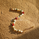This is a bracelet made of S925 sterling silver, red cinnabars, green moss agates and natural white pearls. It's 16cm long with a 3cm extended chain. It comes with a lobster clasp which is easy to be used.