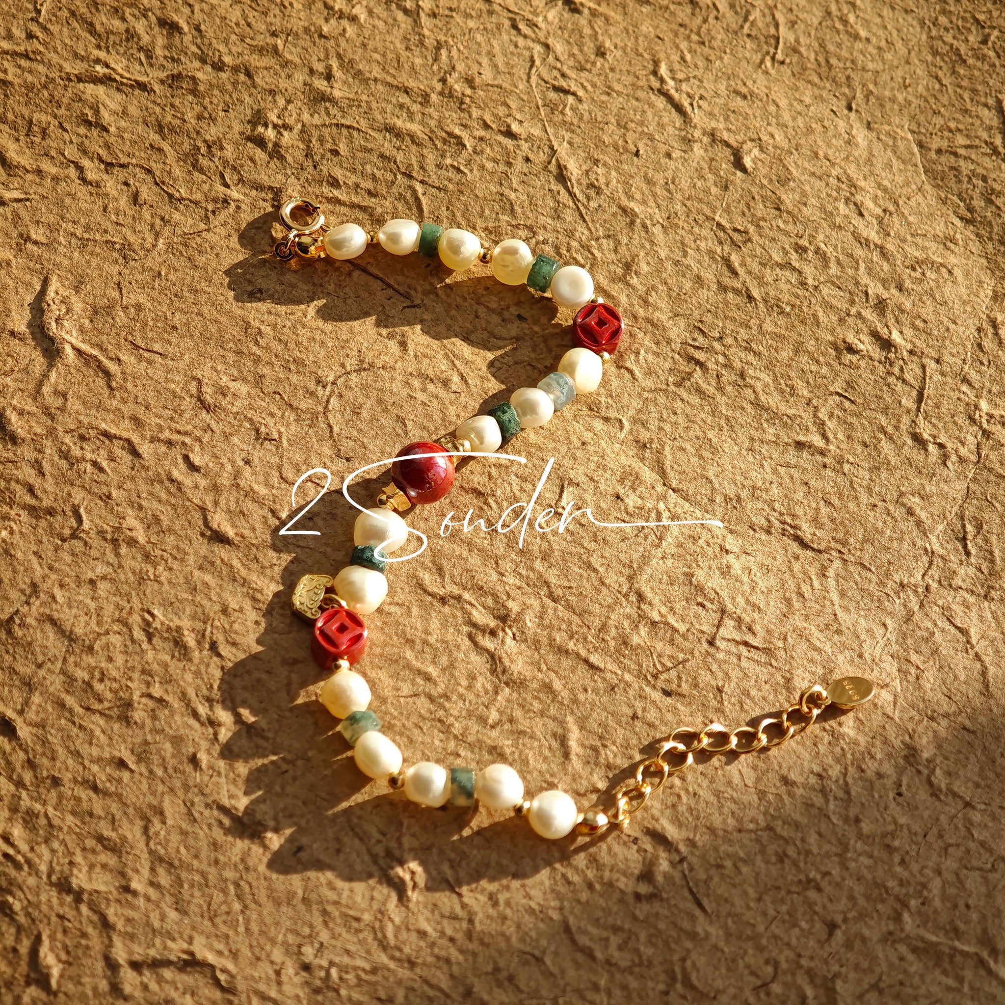 This is a bracelet made of S925 sterling silver, red cinnabars, green moss agates and natural white pearls. It's 16cm long with a 3cm extended chain. It comes with a lobster clasp which is easy to be used.