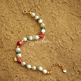 This is a bracelet made of S925 sterling silver, red cinnabars, green moss agates and natural white pearls. It's 16cm long with a 3cm extended chain. It comes with a lobster clasp which is easy to be used.