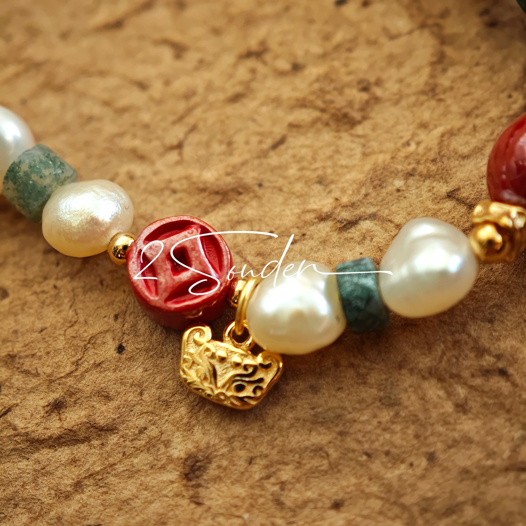 This is a bracelet made of S925 sterling silver, red cinnabars, green moss agates and natural white pearls. It's 16cm long with a 3cm extended chain. It comes with a lobster clasp which is easy to be used.