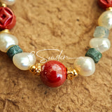 This is a bracelet made of S925 sterling silver, red cinnabars, green moss agates and natural white pearls. It's 16cm long with a 3cm extended chain. It comes with a lobster clasp which is easy to be used.