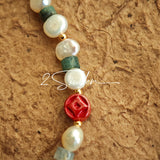 This is a bracelet made of S925 sterling silver, red cinnabars, green moss agates and natural white pearls. It's 16cm long with a 3cm extended chain. It comes with a lobster clasp which is easy to be used.