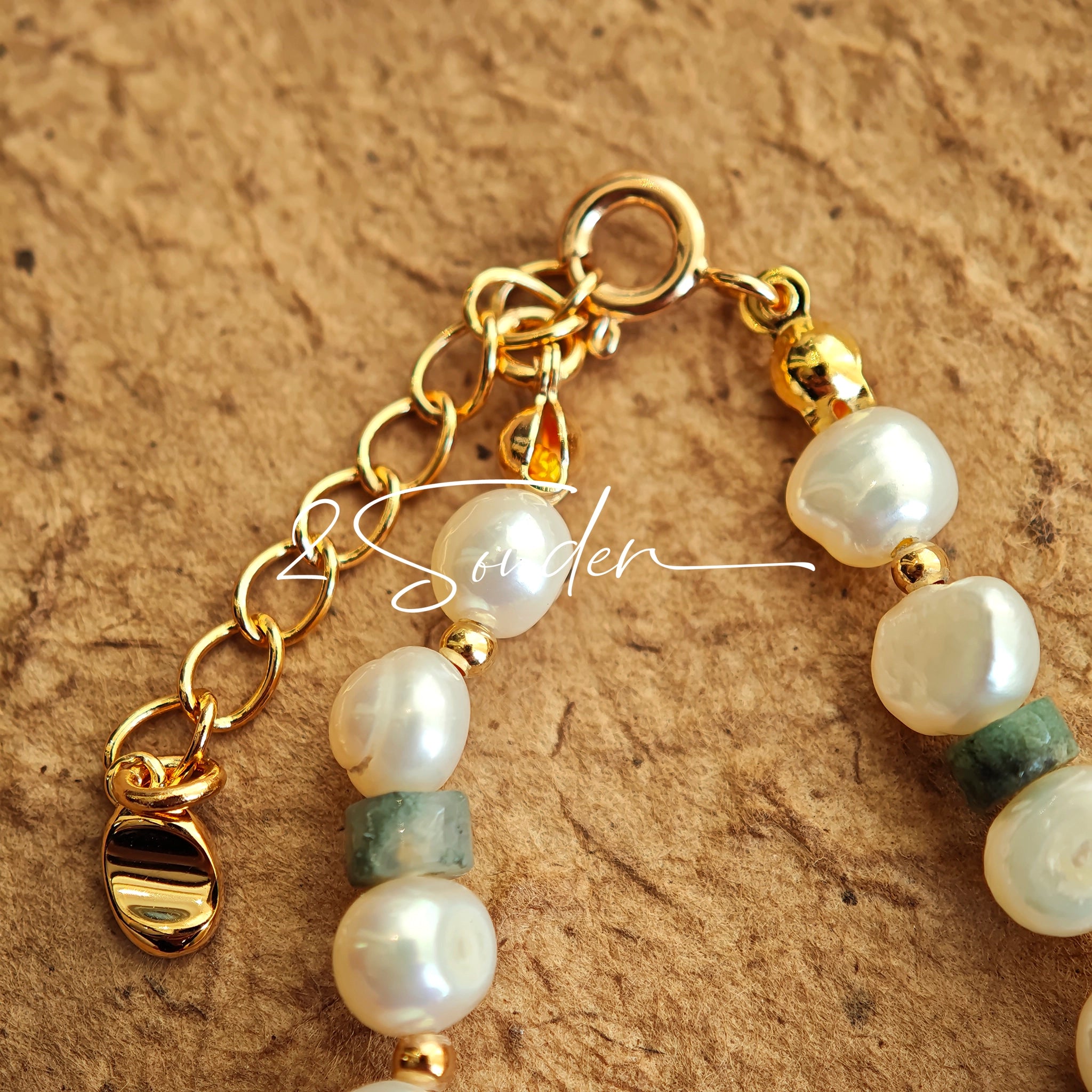 This is a bracelet made of S925 sterling silver, red cinnabars, green moss agates and natural white pearls. It's 16cm long with a 3cm extended chain. It comes with a lobster clasp which is easy to be used.