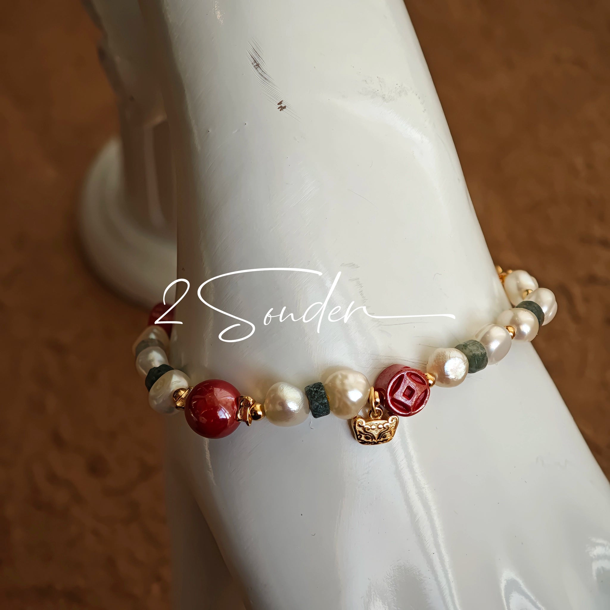 This is a bracelet made of S925 sterling silver, red cinnabars, green moss agates and natural white pearls. It's 16cm long with a 3cm extended chain. It comes with a lobster clasp which is easy to be used.
