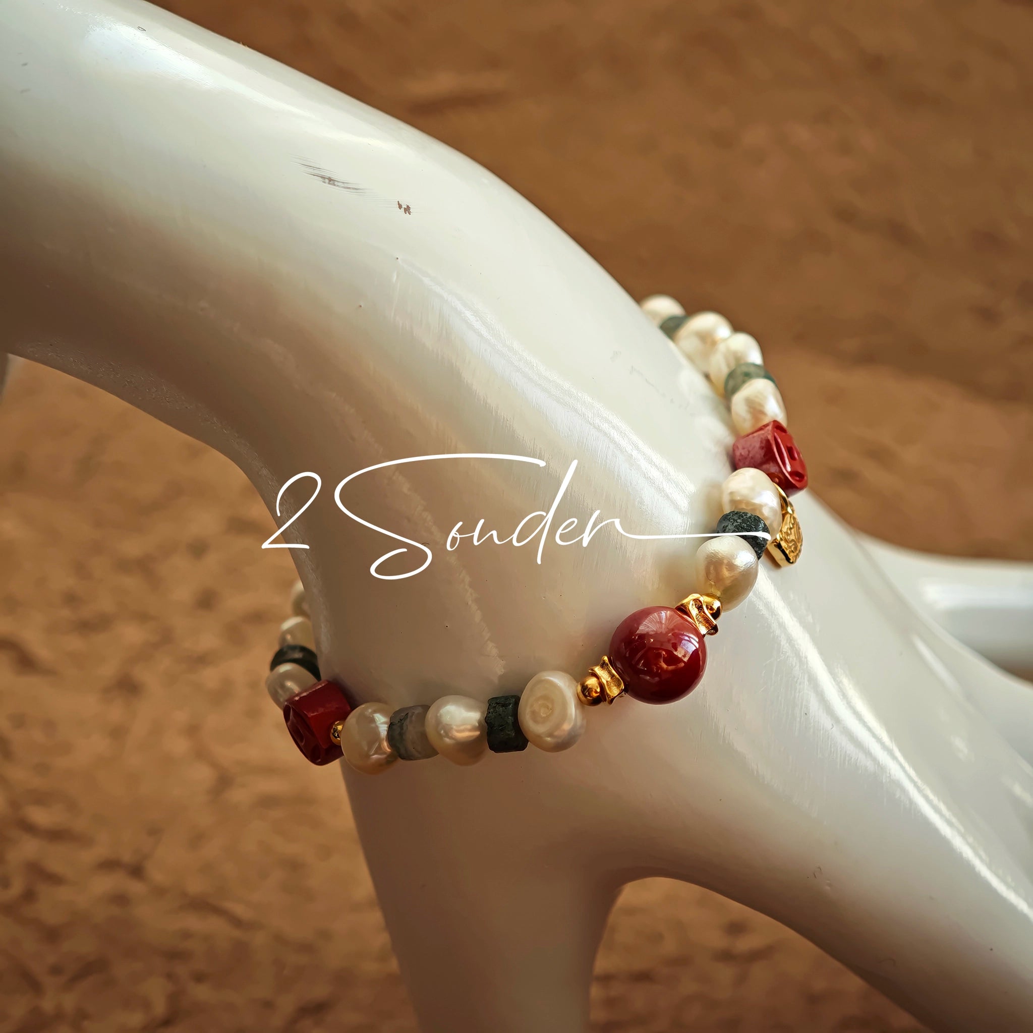 This is a bracelet made of S925 sterling silver, red cinnabars, green moss agates and natural white pearls. It's 16cm long with a 3cm extended chain. It comes with a lobster clasp which is easy to be used.