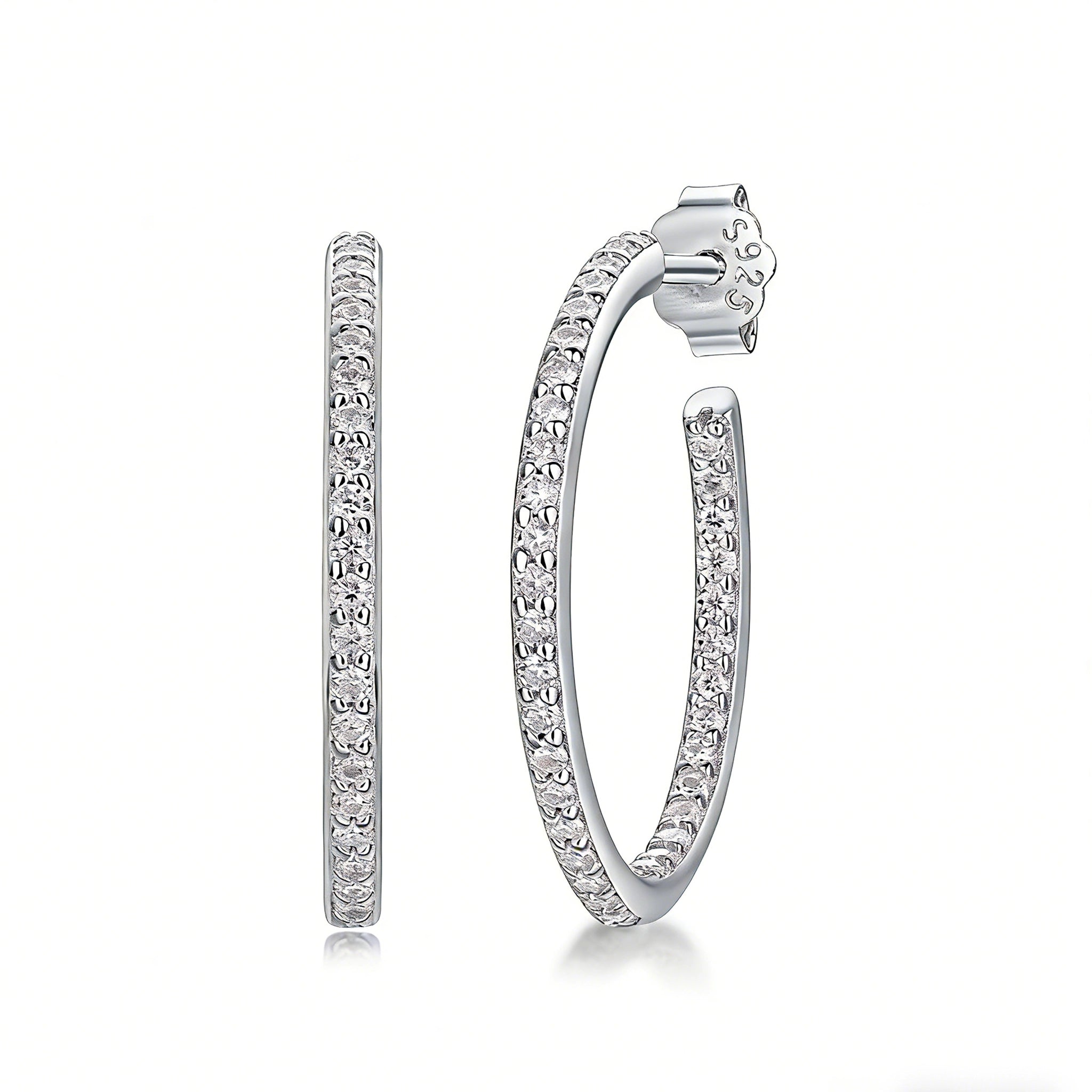 These 925 sterling silver hoop earrings are elegantly lined with sparkling moissanite stones along their entire length, creating a continuous, luminous sheen. The sleek, open-hoop design is secured with a classic butterfly back, blending timeless elegance with modern sophistication. The polished silver finish enhances the brilliance of the moissanite, making them a versatile accessory for both everyday wear and special occasions.