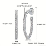 These 925 sterling silver hoop earrings are elegantly lined with sparkling moissanite stones along their entire length, creating a continuous, luminous sheen. The sleek, open-hoop design is secured with a classic butterfly back, blending timeless elegance with modern sophistication. The polished silver finish enhances the brilliance of the moissanite, making them a versatile accessory for both everyday wear and special occasions.
