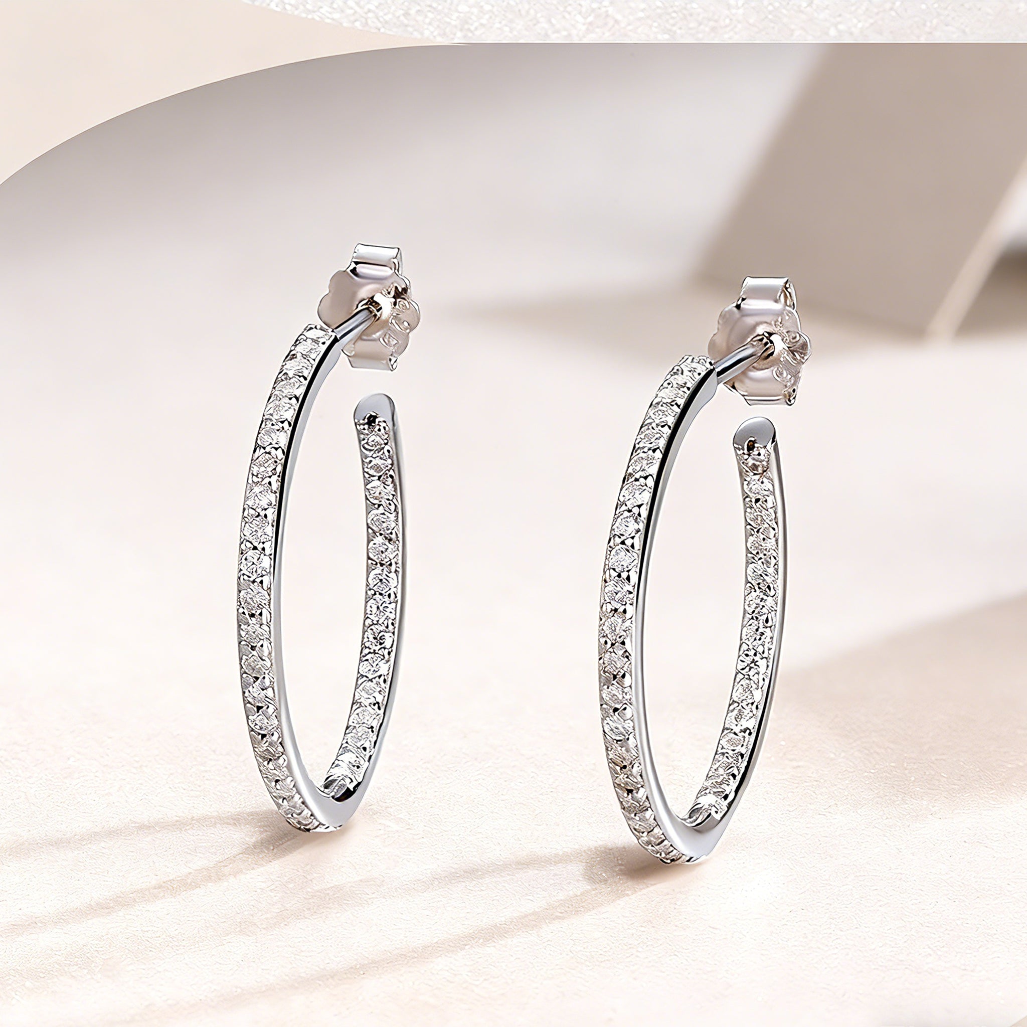 These 925 sterling silver hoop earrings are elegantly lined with sparkling moissanite stones along their entire length, creating a continuous, luminous sheen. The sleek, open-hoop design is secured with a classic butterfly back, blending timeless elegance with modern sophistication. The polished silver finish enhances the brilliance of the moissanite, making them a versatile accessory for both everyday wear and special occasions.