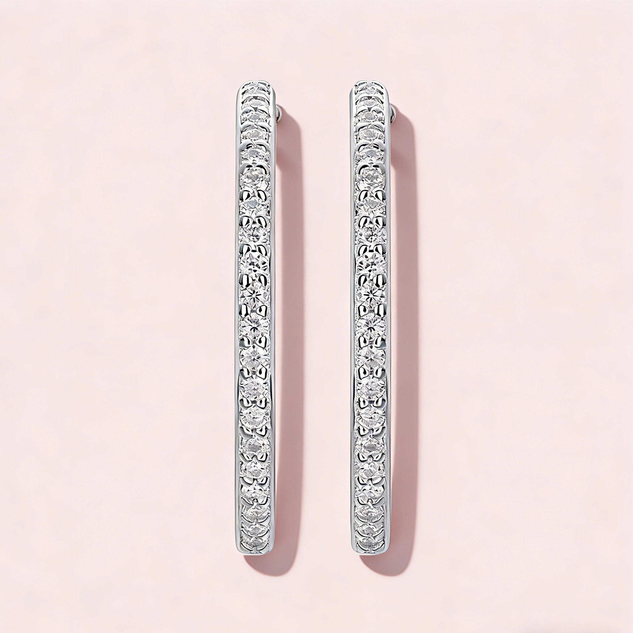 These 925 sterling silver hoop earrings are elegantly lined with sparkling moissanite stones along their entire length, creating a continuous, luminous sheen. The sleek, open-hoop design is secured with a classic butterfly back, blending timeless elegance with modern sophistication. The polished silver finish enhances the brilliance of the moissanite, making them a versatile accessory for both everyday wear and special occasions.
