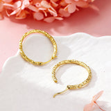 These S925 sterling silver hoop earrings feature a textured, molten lava-like finish in a warm gold tone. The organic, uneven surface creates a rugged, handcrafted appearance, while the classic oval hoop shape adds a timeless, elegant touch to the design. The secure post-back closure ensures comfortable all-day wear.
