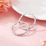 These S925 sterling silver hoop earrings feature a textured, molten lava-like finish in a warm gold tone. The organic, uneven surface creates a rugged, handcrafted appearance, while the classic oval hoop shape adds a timeless, elegant touch to the design. The secure post-back closure ensures comfortable all-day wear.