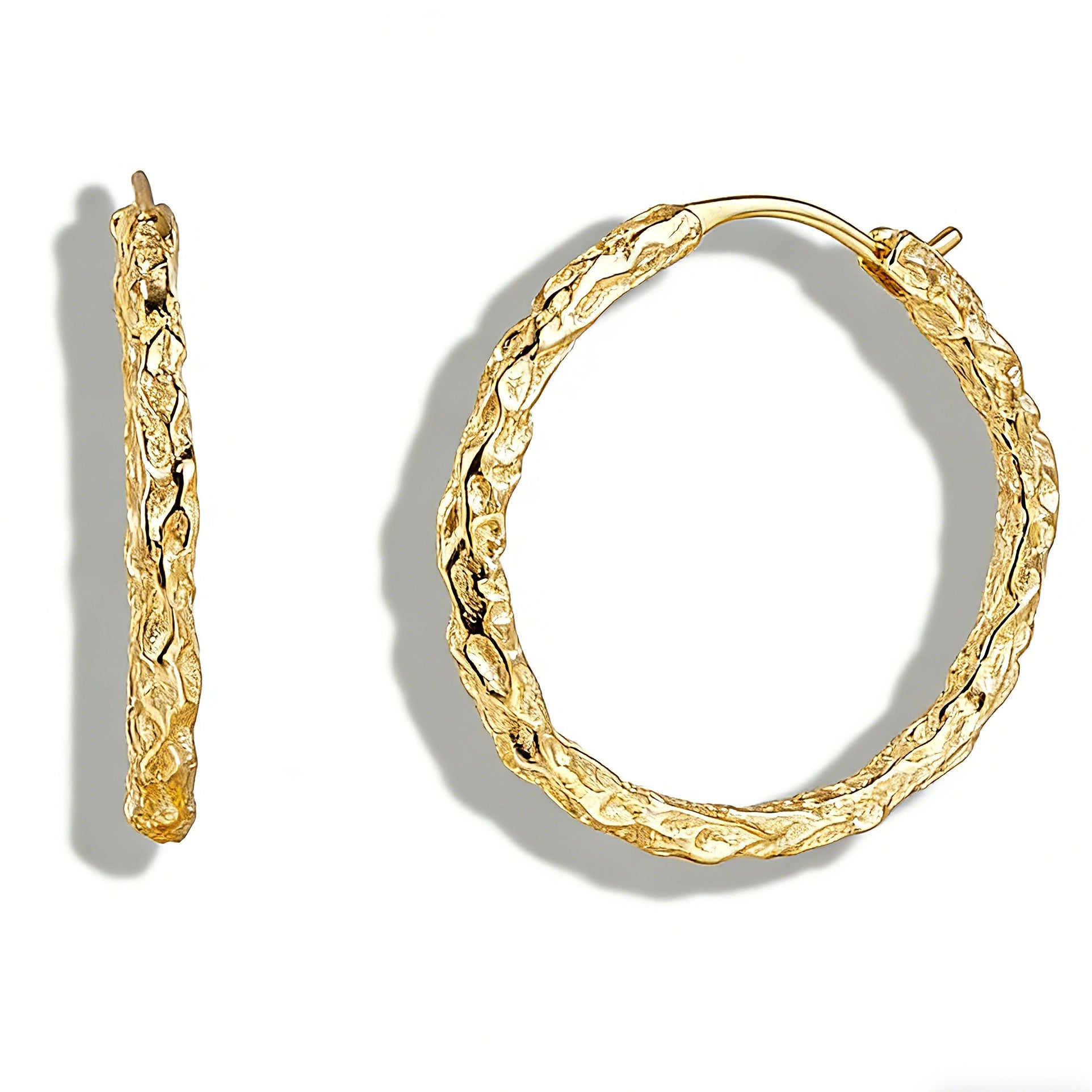 These S925 sterling silver hoop earrings feature a textured, molten lava-like finish in a warm gold tone. The organic, uneven surface creates a rugged, handcrafted appearance, while the classic oval hoop shape adds a timeless, elegant touch to the design. The secure post-back closure ensures comfortable all-day wear.