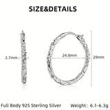 These S925 sterling silver hoop earrings feature a textured, molten lava-like finish in a warm gold tone. The organic, uneven surface creates a rugged, handcrafted appearance, while the classic oval hoop shape adds a timeless, elegant touch to the design. The secure post-back closure ensures comfortable all-day wear.