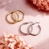 These S925 sterling silver hoop earrings feature a textured, molten lava-like finish in a warm gold tone. The organic, uneven surface creates a rugged, handcrafted appearance, while the classic oval hoop shape adds a timeless, elegant touch to the design. The secure post-back closure ensures comfortable all-day wear.