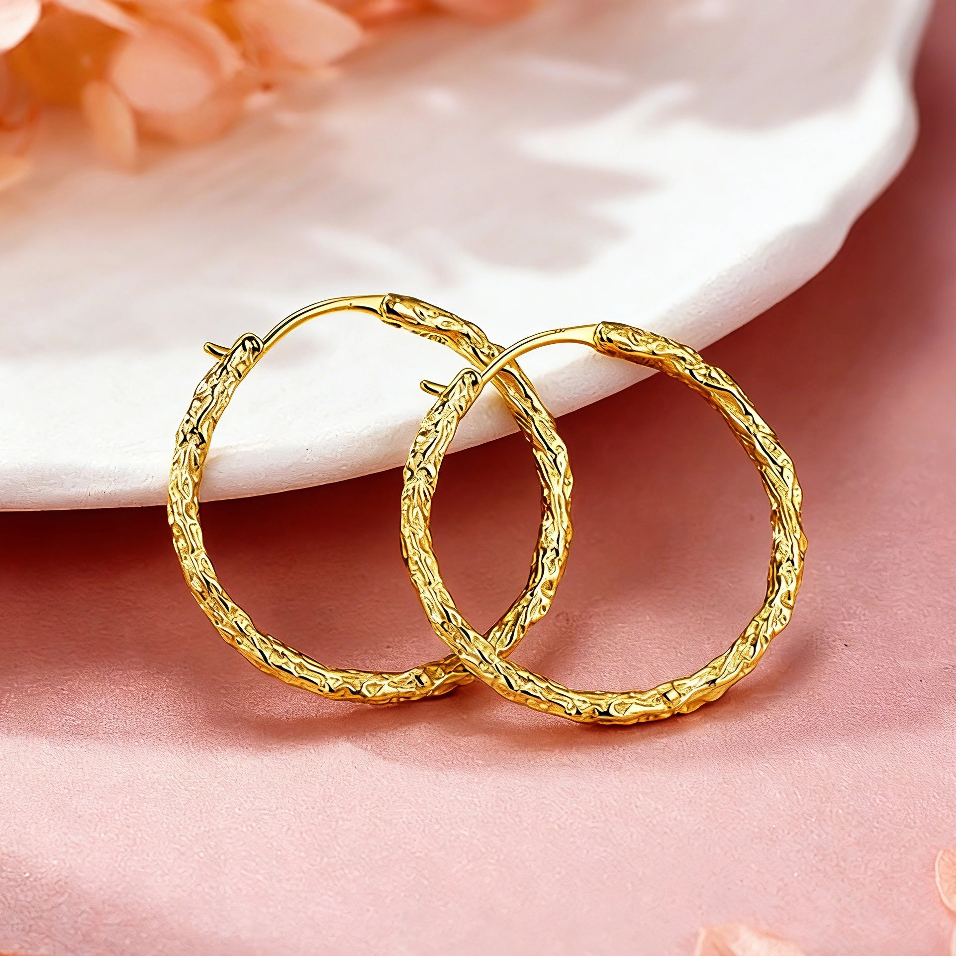 These S925 sterling silver hoop earrings feature a textured, molten lava-like finish in a warm gold tone. The organic, uneven surface creates a rugged, handcrafted appearance, while the classic oval hoop shape adds a timeless, elegant touch to the design. The secure post-back closure ensures comfortable all-day wear.