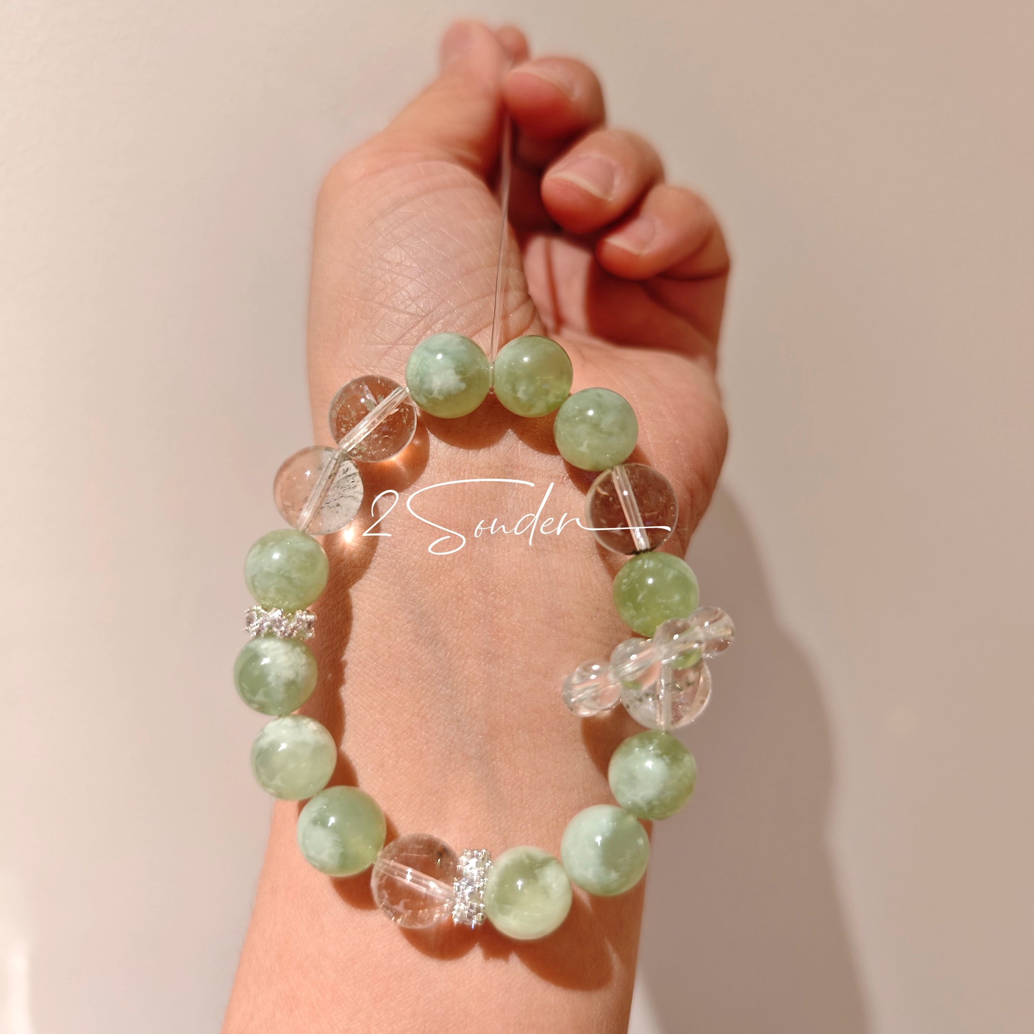 This is a bracelet consists of Xiuyan (Serpentine) Jade, Green Phantom Quartz, Clear Quartz, and 925 sterling silver accents, this gemstone bracelet blends timeless elegance with spiritual meaning.