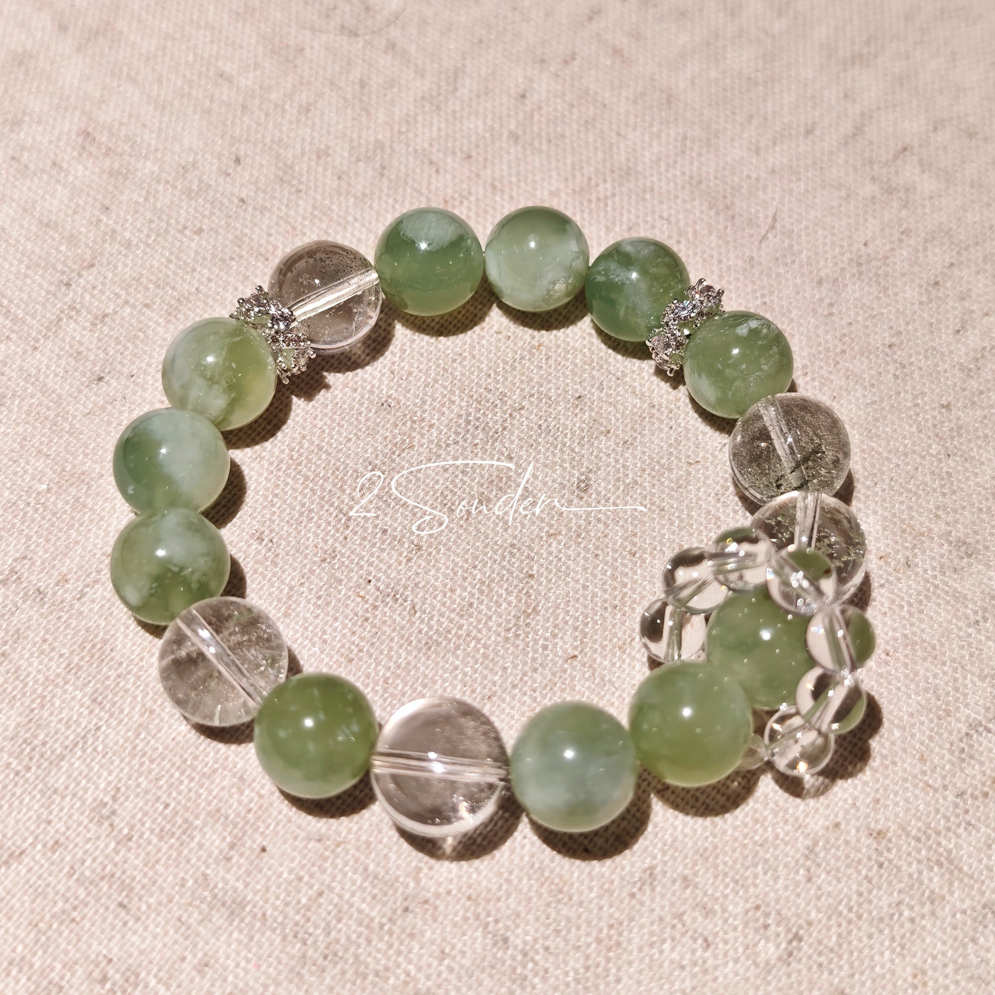 This is a bracelet consists of Xiuyan (Serpentine) Jade, Green Phantom Quartz, Clear Quartz, and 925 sterling silver accents, this gemstone bracelet blends timeless elegance with spiritual meaning.