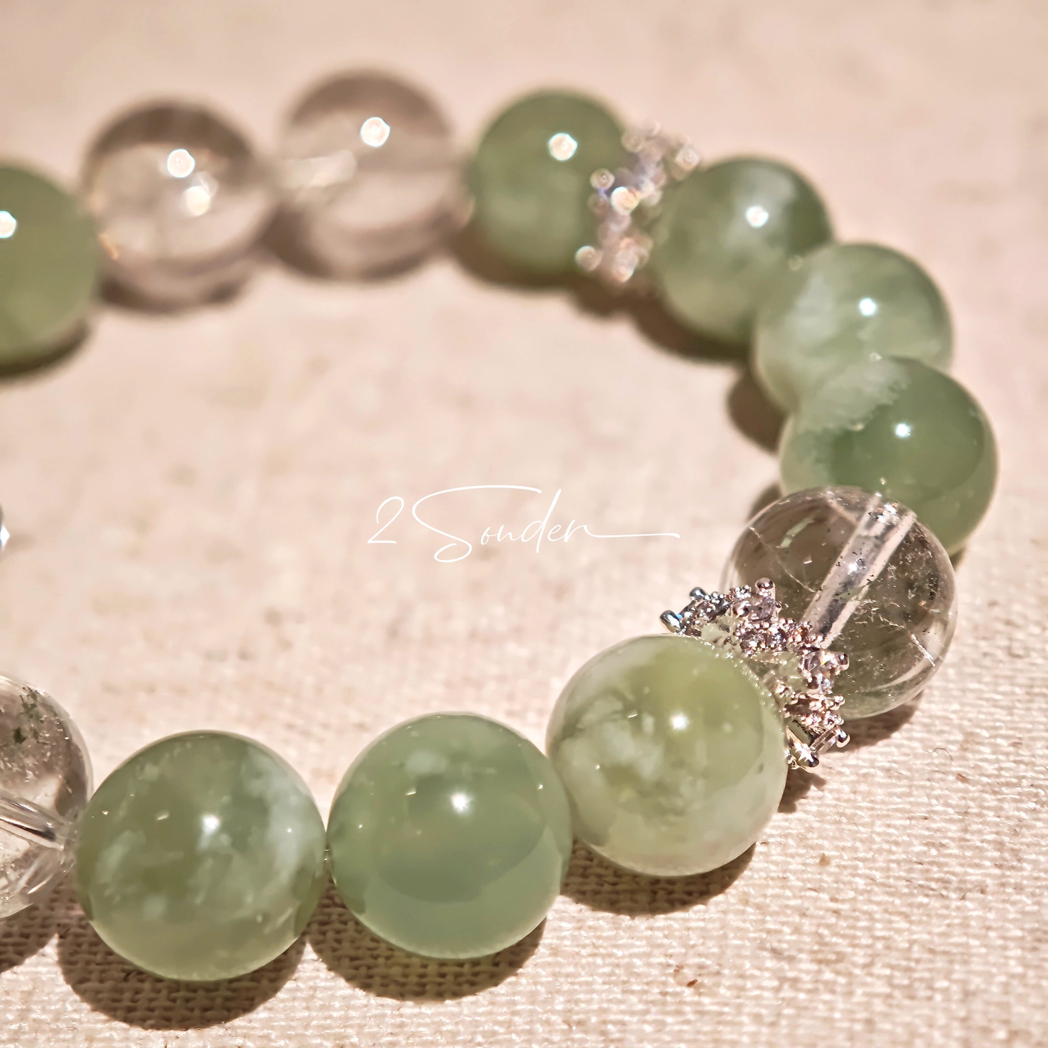This is a bracelet consists of Xiuyan (Serpentine) Jade, Green Phantom Quartz, Clear Quartz, and 925 sterling silver accents, this gemstone bracelet blends timeless elegance with spiritual meaning.