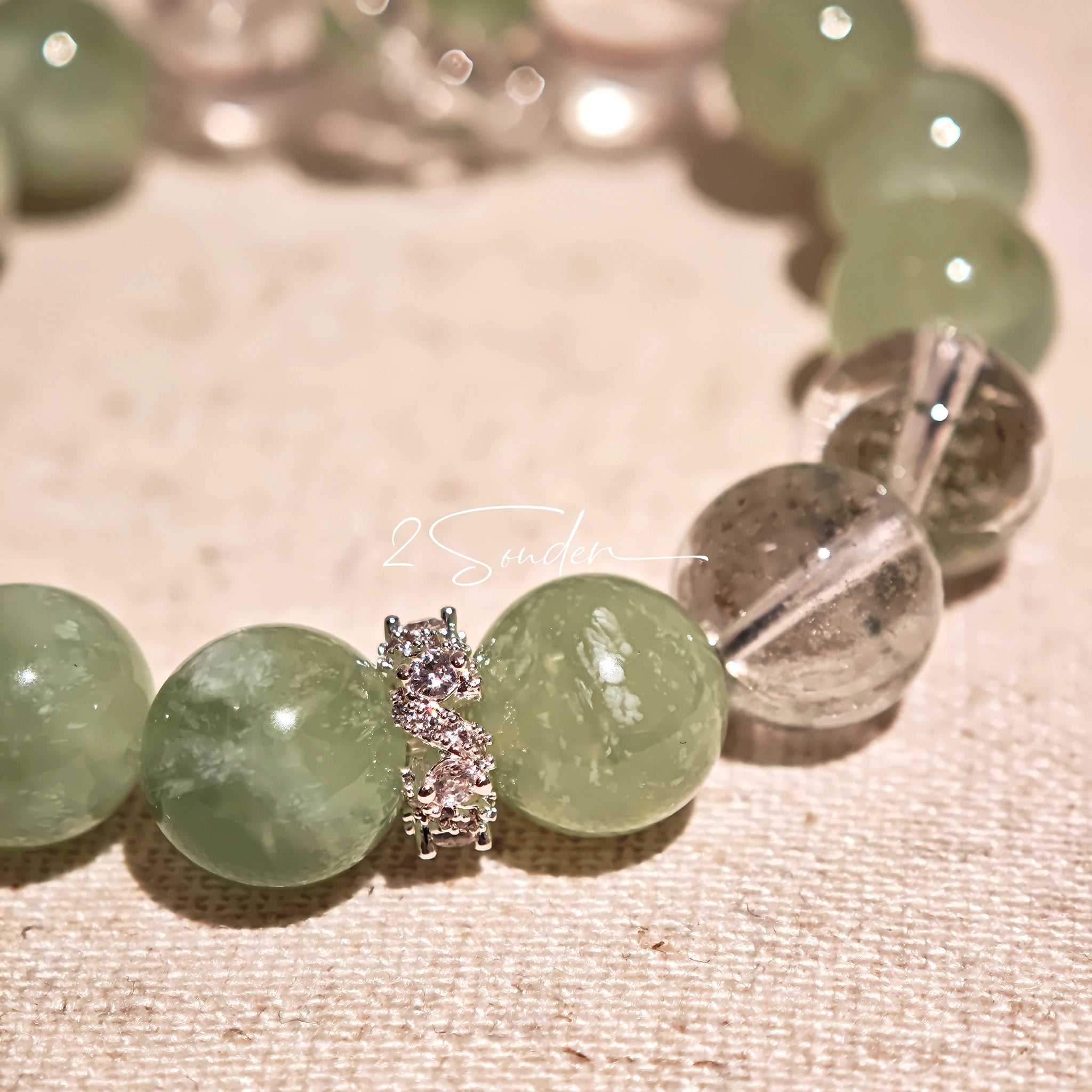 This is a bracelet consists of Xiuyan (Serpentine) Jade, Green Phantom Quartz, Clear Quartz, and 925 sterling silver accents, this gemstone bracelet blends timeless elegance with spiritual meaning.