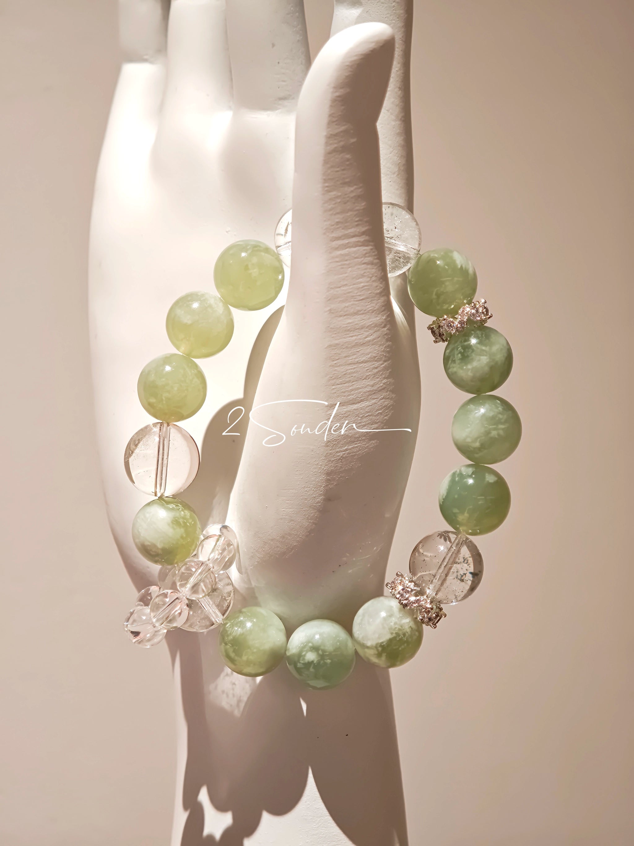 This is a bracelet consists of Xiuyan (Serpentine) Jade, Green Phantom Quartz, Clear Quartz, and 925 sterling silver accents, this gemstone bracelet blends timeless elegance with spiritual meaning.