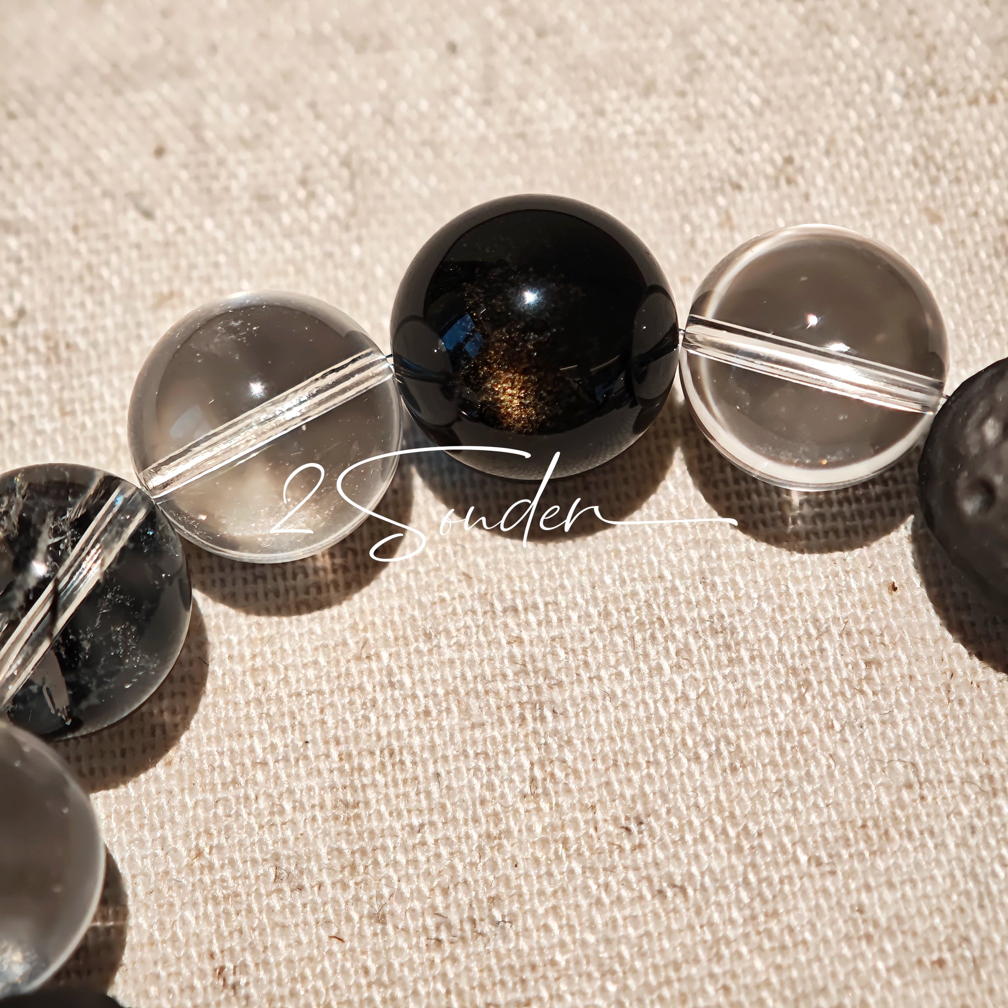 This is a bracelet consists of silver sheen obsidian, clear quartz, herkimer diamonds, meteorite and edgy accents.