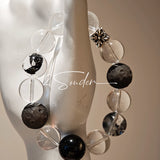 This is a bracelet consists of silver sheen obsidian, clear quartz, herkimer diamonds, meteorite and edgy accents.