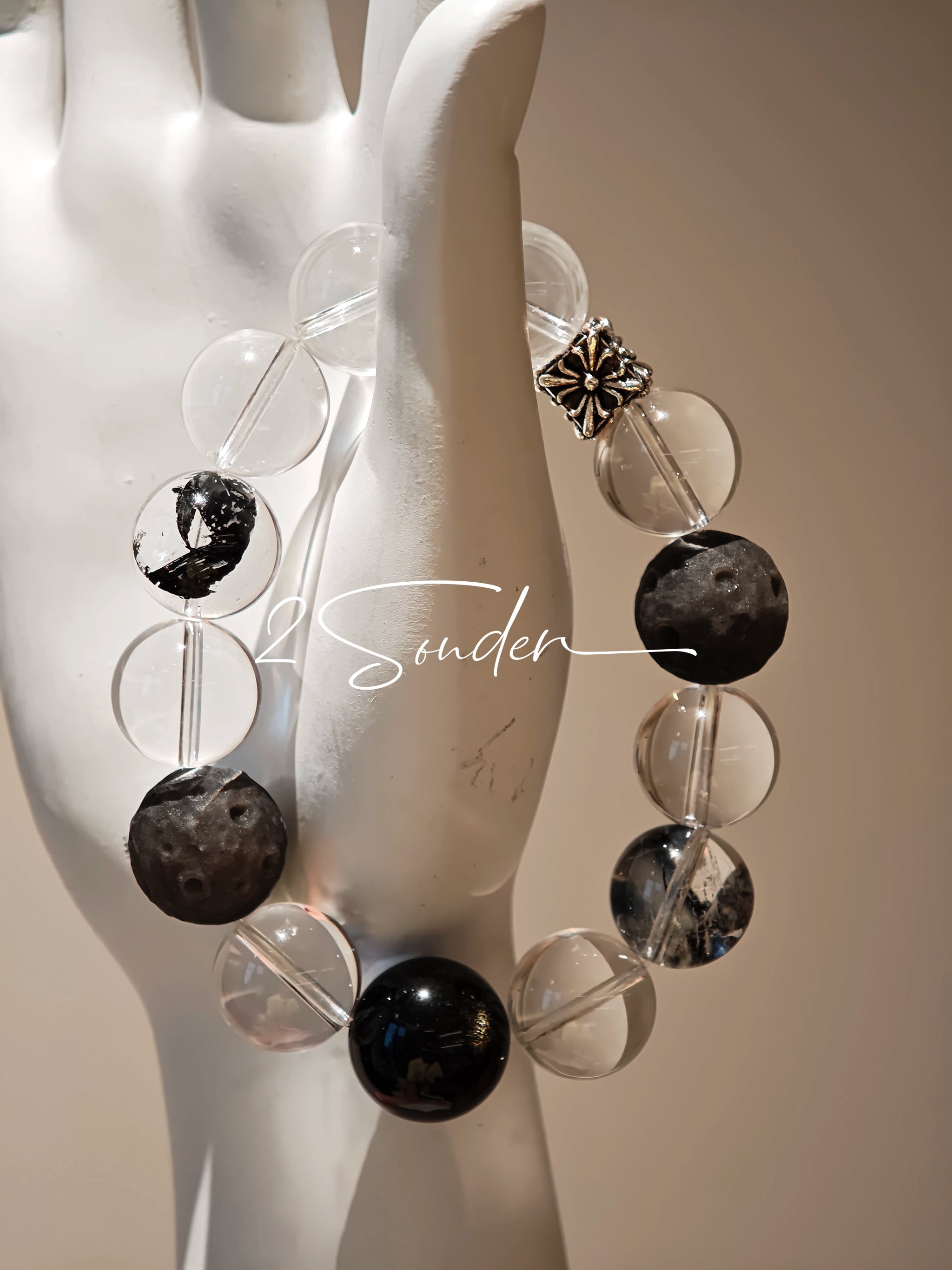 This is a bracelet consists of silver sheen obsidian, clear quartz, herkimer diamonds, meteorite and edgy accents.