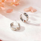 These sterling silver stud earrings are inspired by the natural, smooth folds of tin foil. Their surface texture resembles the wrinkles on tin foil, presenting a stunning sheen. The simple yet stylish design makes them versatile and practical, easily adding a touch of modern fashion to your everyday outfits.