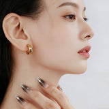 These sterling silver stud earrings are inspired by the natural, smooth folds of tin foil. Their surface texture resembles the wrinkles on tin foil, presenting a stunning sheen. The simple yet stylish design makes them versatile and practical, easily adding a touch of modern fashion to your everyday outfits.