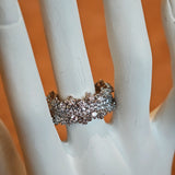 This snowflake zircon open ring features an intricate and textured band, adorned with clusters of sparkling zircon stones that mimic delicate snowflakes. Its adjustable open design ensures a comfortable fit, while the polished copper alloy metal reflects light beautifully, creating an elegant, frosty aesthetic. The detailed craftsmanship gives it a luxurious, eye-catching appearance ideal for adding a wintry charm to any look.