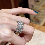 This snowflake zircon open ring features an intricate and textured band, adorned with clusters of sparkling zircon stones that mimic delicate snowflakes. Its adjustable open design ensures a comfortable fit, while the polished copper alloy metal reflects light beautifully, creating an elegant, frosty aesthetic. The detailed craftsmanship gives it a luxurious, eye-catching appearance ideal for adding a wintry charm to any look.