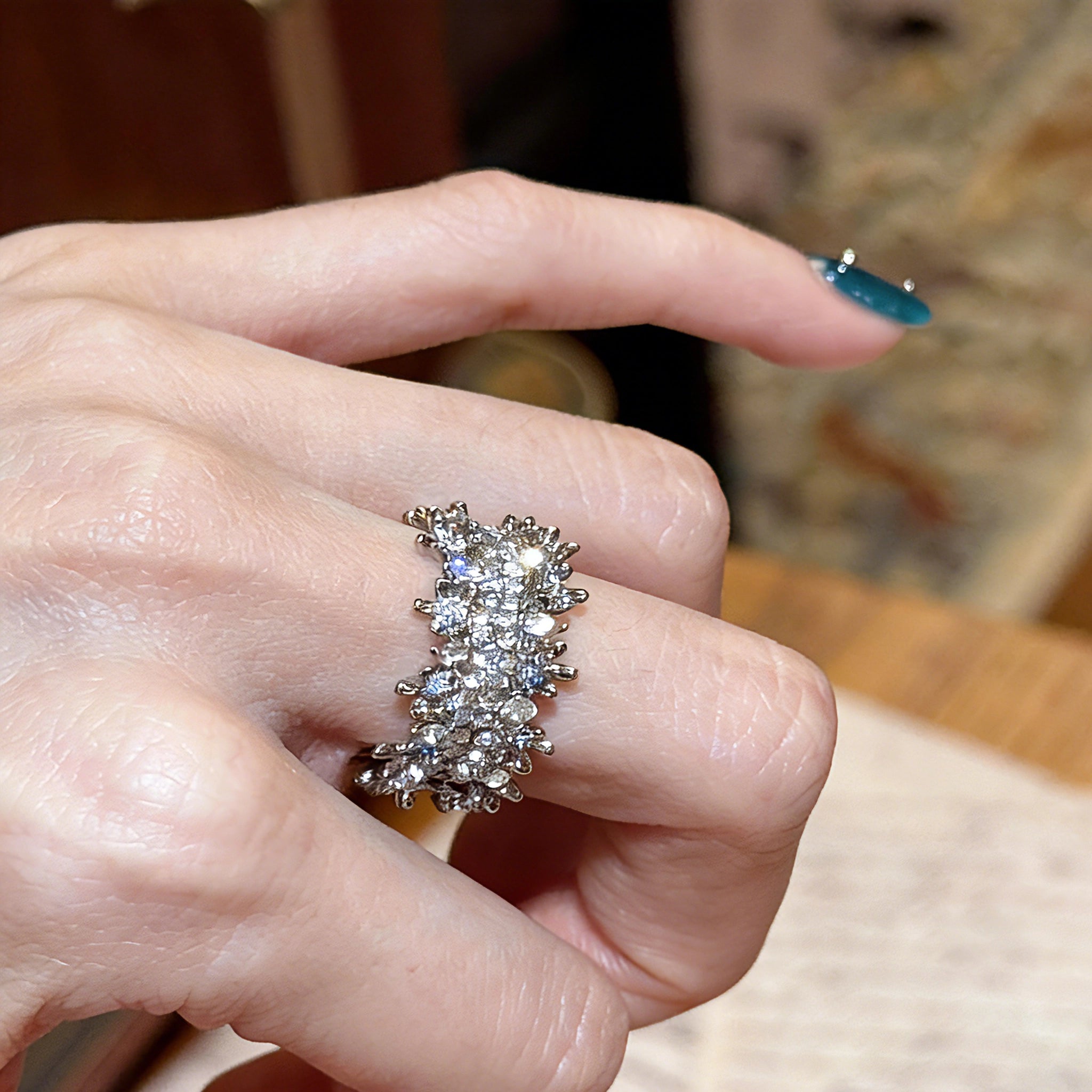 This snowflake zircon open ring features an intricate and textured band, adorned with clusters of sparkling zircon stones that mimic delicate snowflakes. Its adjustable open design ensures a comfortable fit, while the polished copper alloy metal reflects light beautifully, creating an elegant, frosty aesthetic. The detailed craftsmanship gives it a luxurious, eye-catching appearance ideal for adding a wintry charm to any look.