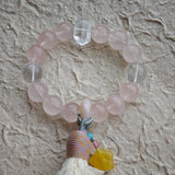 Warm blush stones fuse with cool azure needles, then amber starlight, agate glide, and tassel fringe add bohemian poetry.