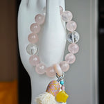 Gentle pink pulses beside celestial blue, and an amber star, agate bead, and airy tassel lend free-spirited sparkle.