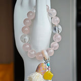 Gentle pink pulses beside celestial blue, and an amber star, agate bead, and airy tassel lend free-spirited sparkle.