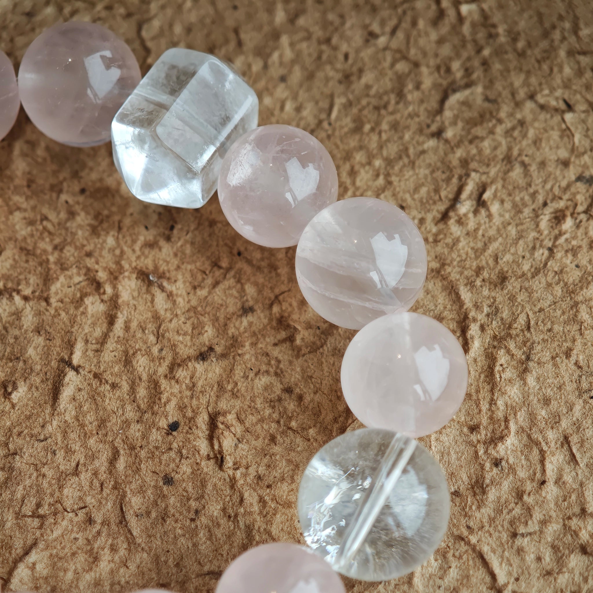 Rose quartz whispers love; blue-needle crystal sings mystery; amber star, agate bead, and tassel answer with bohemian flair.