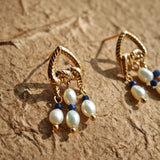 This is a pair of earrings that made of Lapis Lazuli, pearl and sterling silver. It's vintage and elegant.