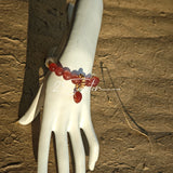 This bracelet features a beautiful blend of translucent white phantom quartz beads and rich pink strawberry quartz beads, creating a striking contrast. Adorned with delicate gold-toned accents and a charming red cat's paw charm, it exudes a sweet and elegant vibe. The combination of smooth crystal spheres and a playful pendant makes it a lovely and eye-catching accessory.