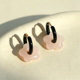 These summer candy-colored hoop earrings feature cute carved natural stone flower pendants paired with glossy enamel-coated metal hoops. They come in a vibrant palette of playful bright hues, creating a fresh, sweet and youthful summery style. The minimalist huggie hoop structure with delicate floral charms makes them lightweight and versatile for daily casual wear.