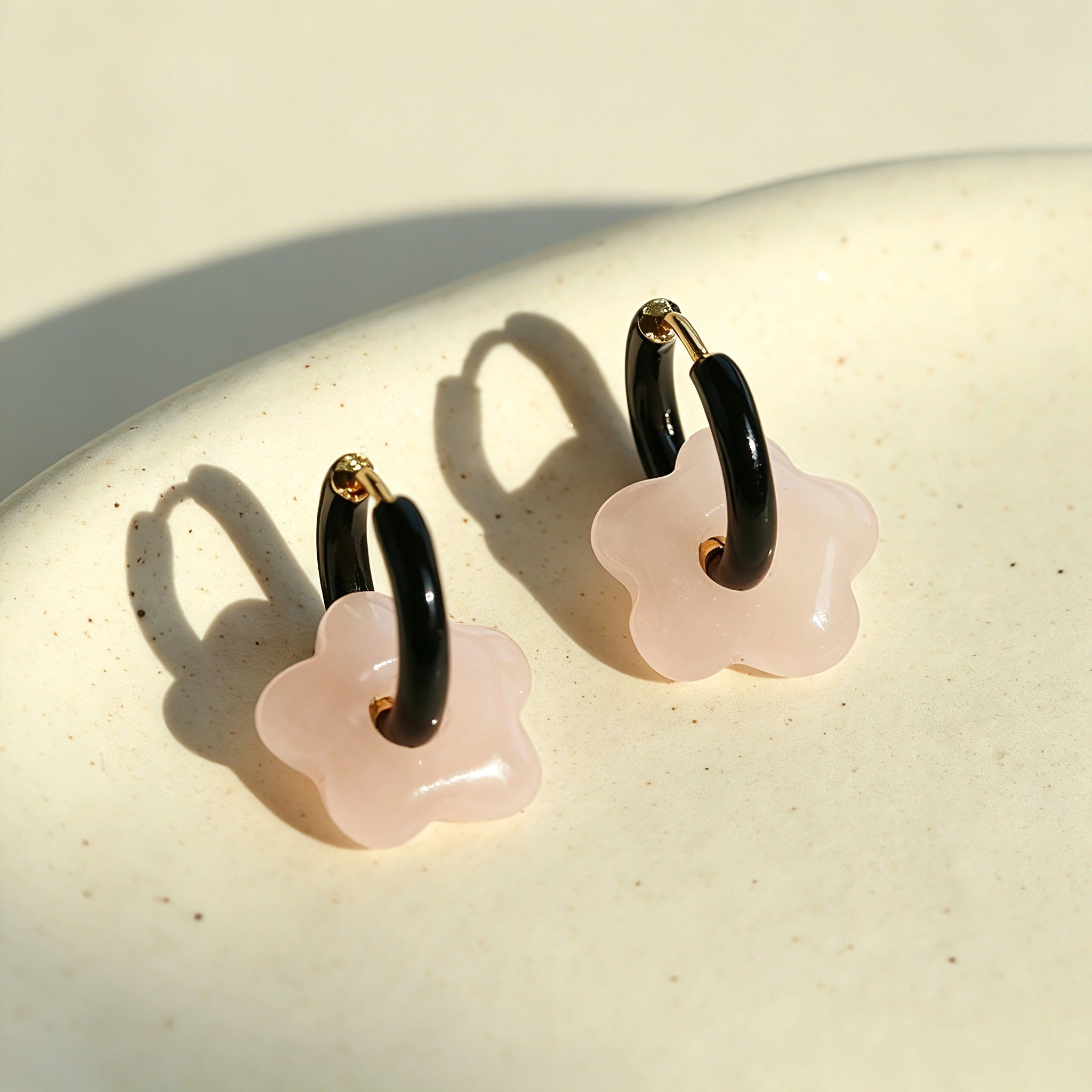 These summer candy-colored hoop earrings feature cute carved natural stone flower pendants paired with glossy enamel-coated metal hoops. They come in a vibrant palette of playful bright hues, creating a fresh, sweet and youthful summery style. The minimalist huggie hoop structure with delicate floral charms makes them lightweight and versatile for daily casual wear.