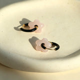 These summer candy-colored hoop earrings feature cute carved natural stone flower pendants paired with glossy enamel-coated metal hoops. They come in a vibrant palette of playful bright hues, creating a fresh, sweet and youthful summery style. The minimalist huggie hoop structure with delicate floral charms makes them lightweight and versatile for daily casual wear.